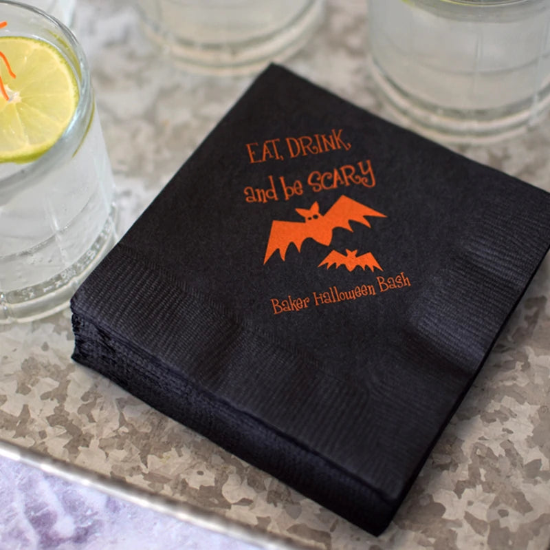 Tippytoad Halloween cocktail napkins black with orange bat design Eat Drink and be Scary print stacked by glasses