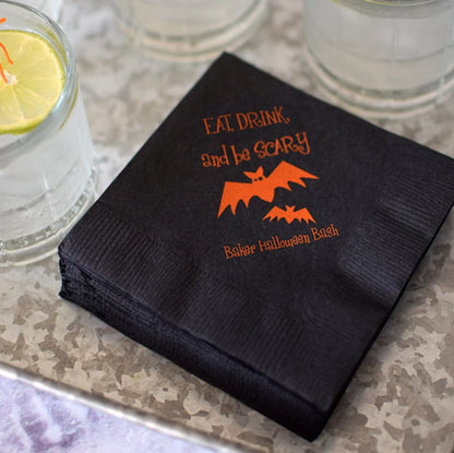 Tippytoad Halloween cocktail napkins black with orange bat design Eat Drink and be Scary print stacked by glasses