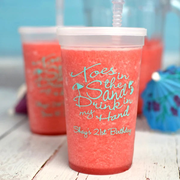 Clear translucent color 22 oz stadium cups personalized with toes in the sand design and 1 line of text in robins egg blue for 21st birthday party drinks
