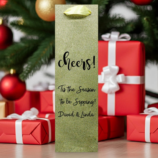 custom printed glitter christmas wine bottle gift bags light gold glitter bag reading cheers with wrapped red gifts under tree