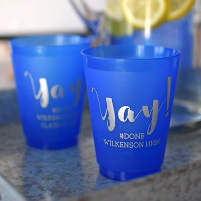 16 Oz. blue frosted graduation cups personalized with 'Yay!' design and 2 lines of custom text in silver imprint color