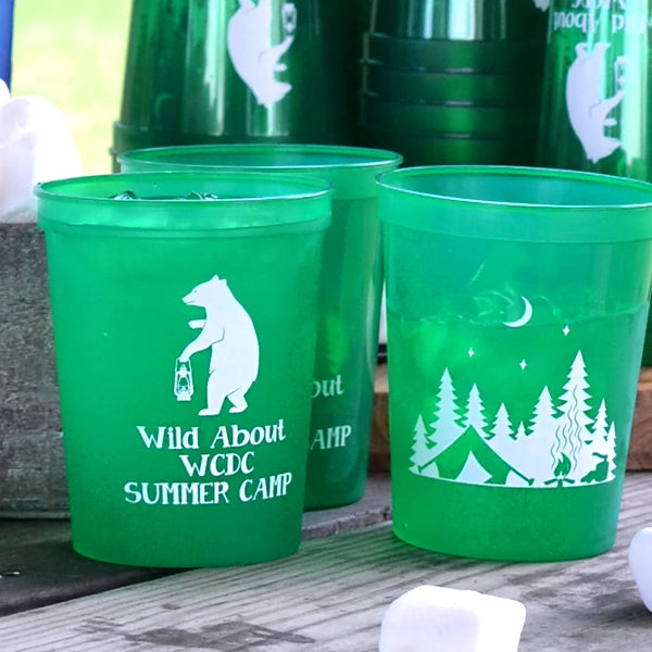 Translucent green summer party cups personalized with camping bear design and custom text on front side and campsite on back side in white print