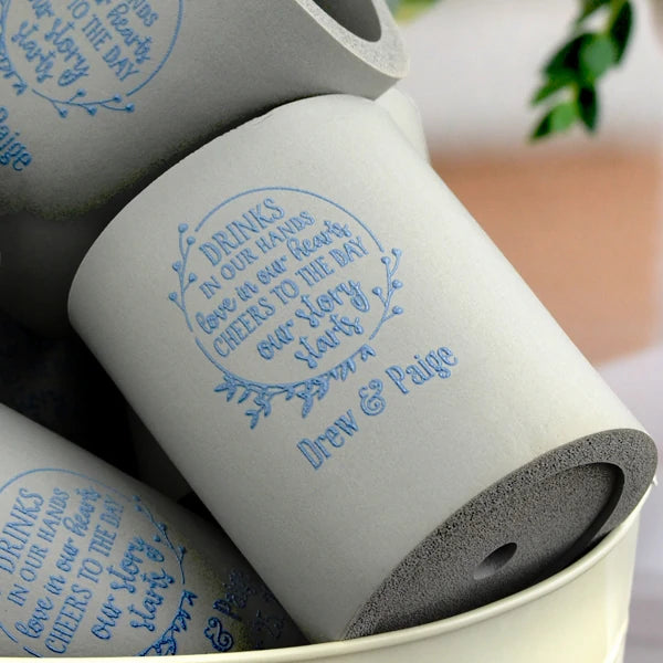 Grey color can cooler wedding favors personalized with drinks in our hands design and bride and groom name in blue print