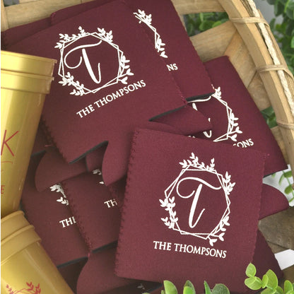 Burgundy color wedding can huggers personalized with geometric wreath design and married couples name in ivory print