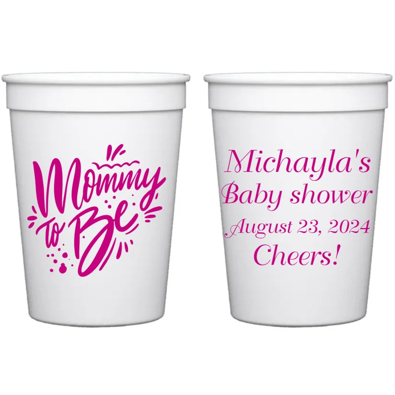 White color 12 oz. plastic baby shower cups personalized with mommy to be design on front side and 4 lines of custom text on back side in fuchsia print