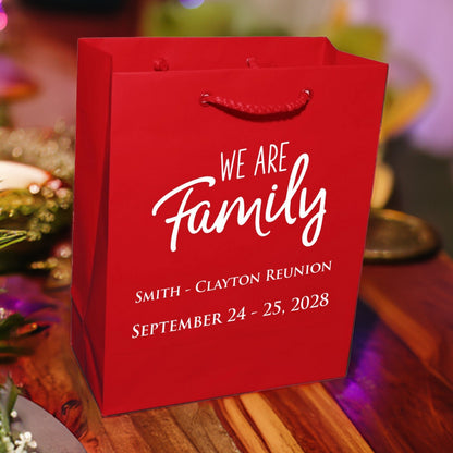 Red personalized family reunion welcome gift bags with white text for Smith Clayton reunion 2028