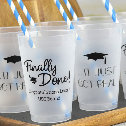 Clear frosted 12 oz. graduation cups personalized with "Finally Done!" design, "Congratulations [Graduate Name]!, USC Bound" and "..IT JUST GOT REAL Grad Cap" design in black print