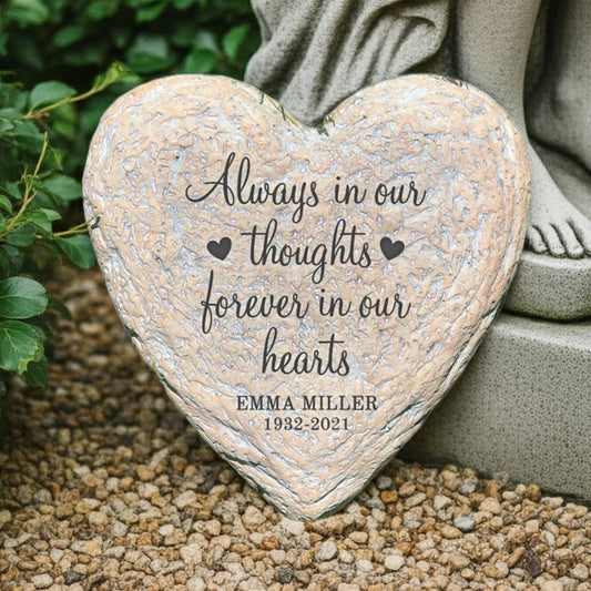 Forever in our hearts personalized heart garden stone next to a stone statue