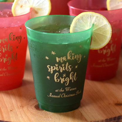Frosted plastic Christmas party cups in green and red with holiday designs for festive celebrations