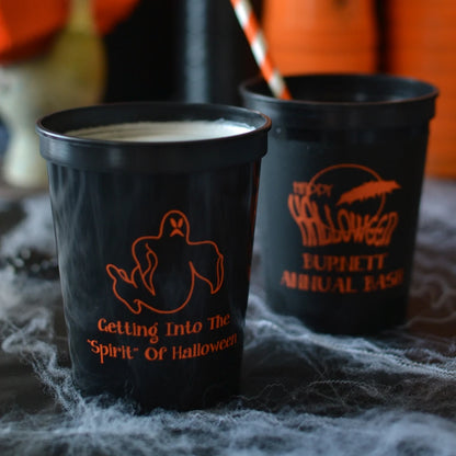 Black 16 oz. halloween stadium cups personalized with ghost and 2 lines of text on front side and happy halloween design and 2 lines of text on back side in orange print