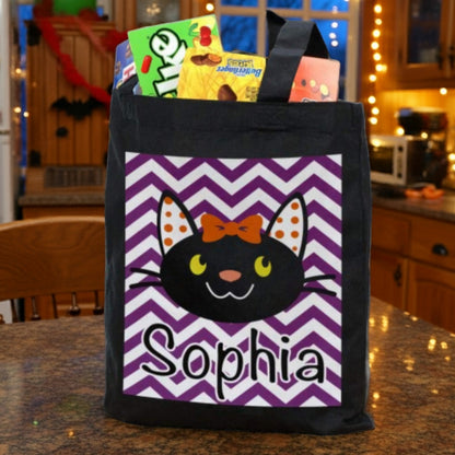 girl black cat personalized trick or treat bag with Sophia name on purple chevron panel filled with candy in kitchen