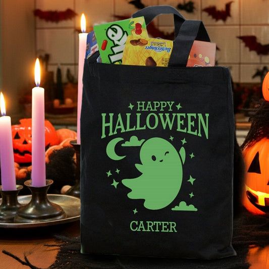 glow in the dark ghost personalized trick or treat bag black tote with green ghost design and name Carter filled with candy
