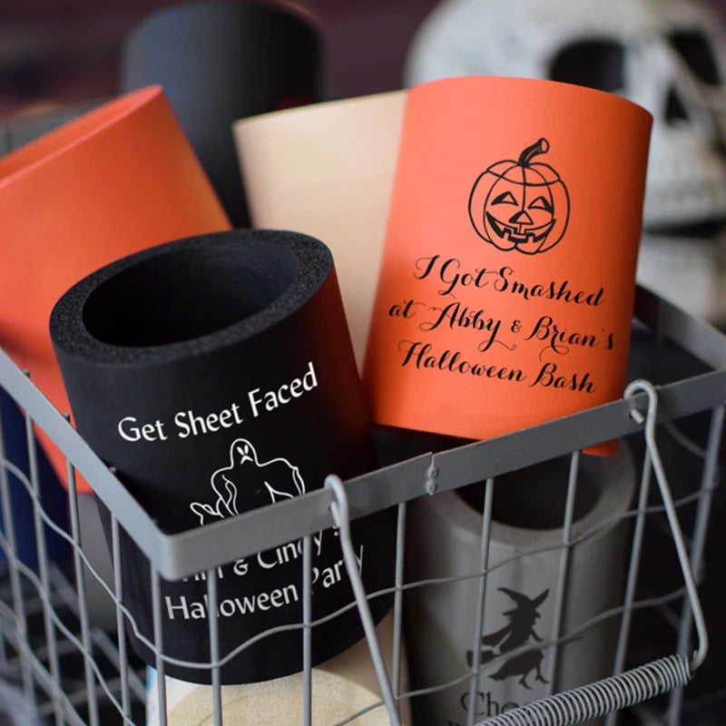 Tippytoad Halloween can coolers featuring orange jack o lantern and black ghost designs in a wire basket