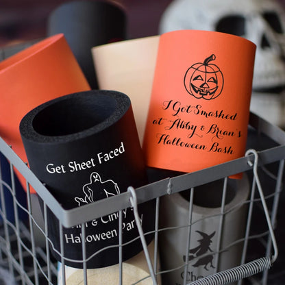 Tippytoad Halloween can coolers featuring orange jack o lantern and black ghost designs in a wire basket
