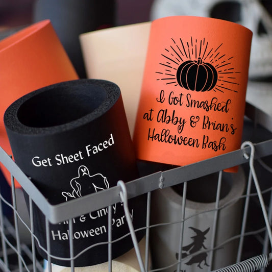 Tippytoad Halloween can coolers set in a wire basket showing orange pumpkin and black ghost designs for parties