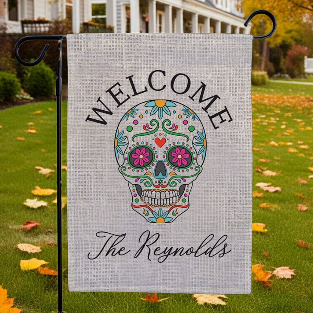 Halloween garden flag featuring a colorful sugar skull welcome design with personalized The Reynolds