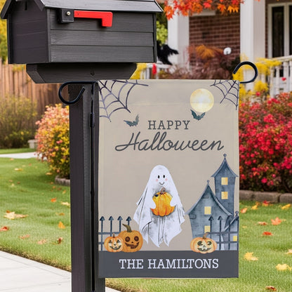 Halloween garden flag with smiling ghost holding pumpkin pumpkins haunted house Happy Halloween personalized The Hamiltons