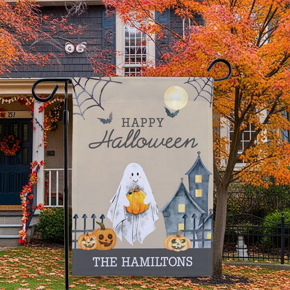 Halloween garden flag with smiling ghost holding pumpkin jack o lanterns and haunted house