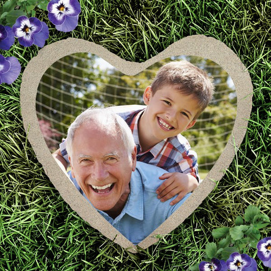 Heart shape custom photo garden stone featuring a grandfather and grandson in grass