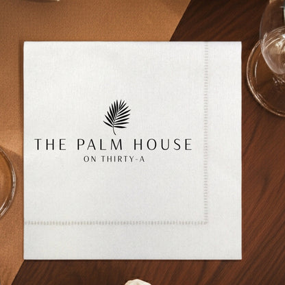 Elegant hemstitch cocktail napkins featuring The Palm House logo for destination wedding reception