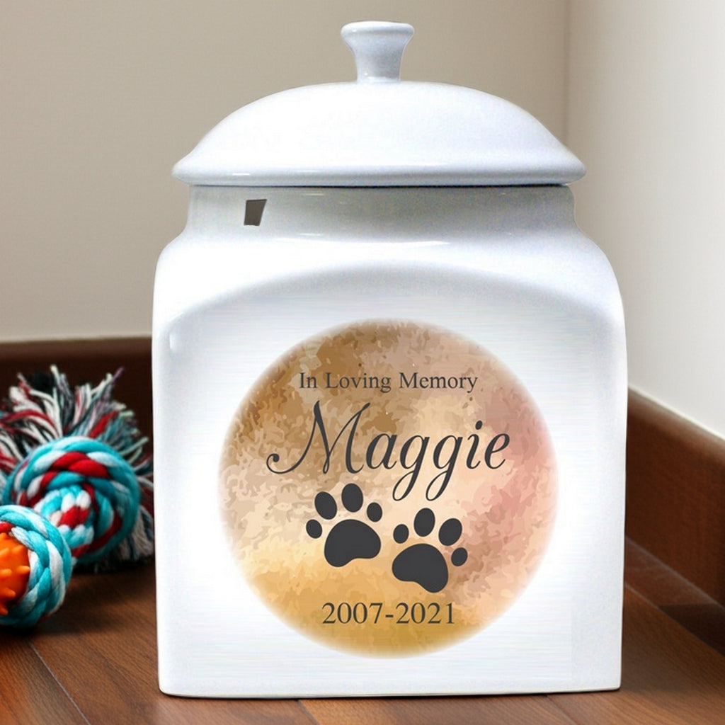 In loving memory personalized pet urn with paw prints and name Maggie 2007-2021