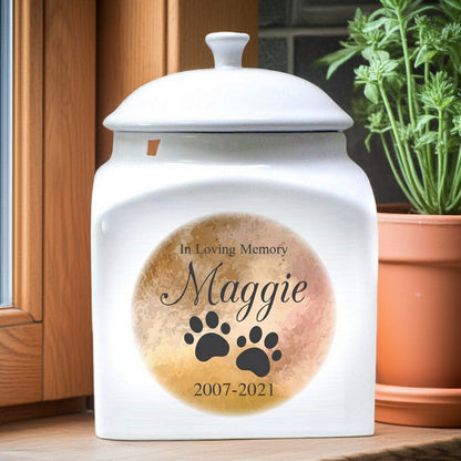 In loving memory white ceramic personalized pet urn with paw prints and custom name Maggie