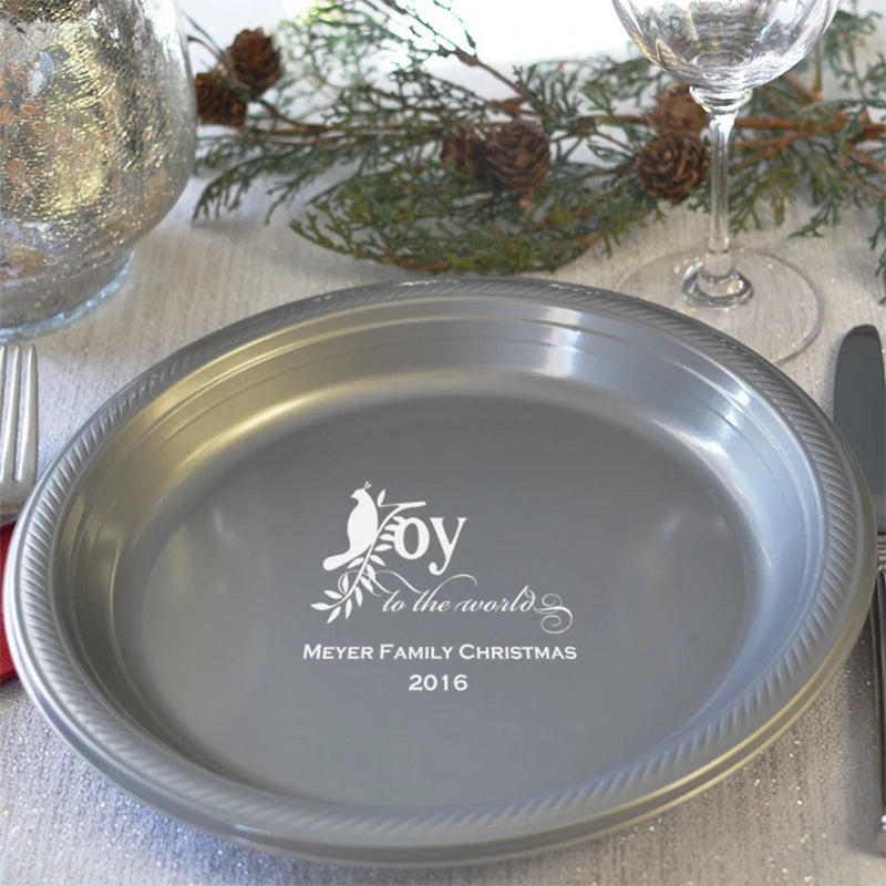 Silver plastic Christmas dinner plate personalized with Joy to the world design and family name in white print.