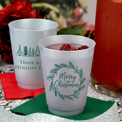 Silver frosted 16 oz. christmas punch cups personalized with Merry Christmas Wreath design on front side and Holiday Trees design on back side with custom text in forest green print