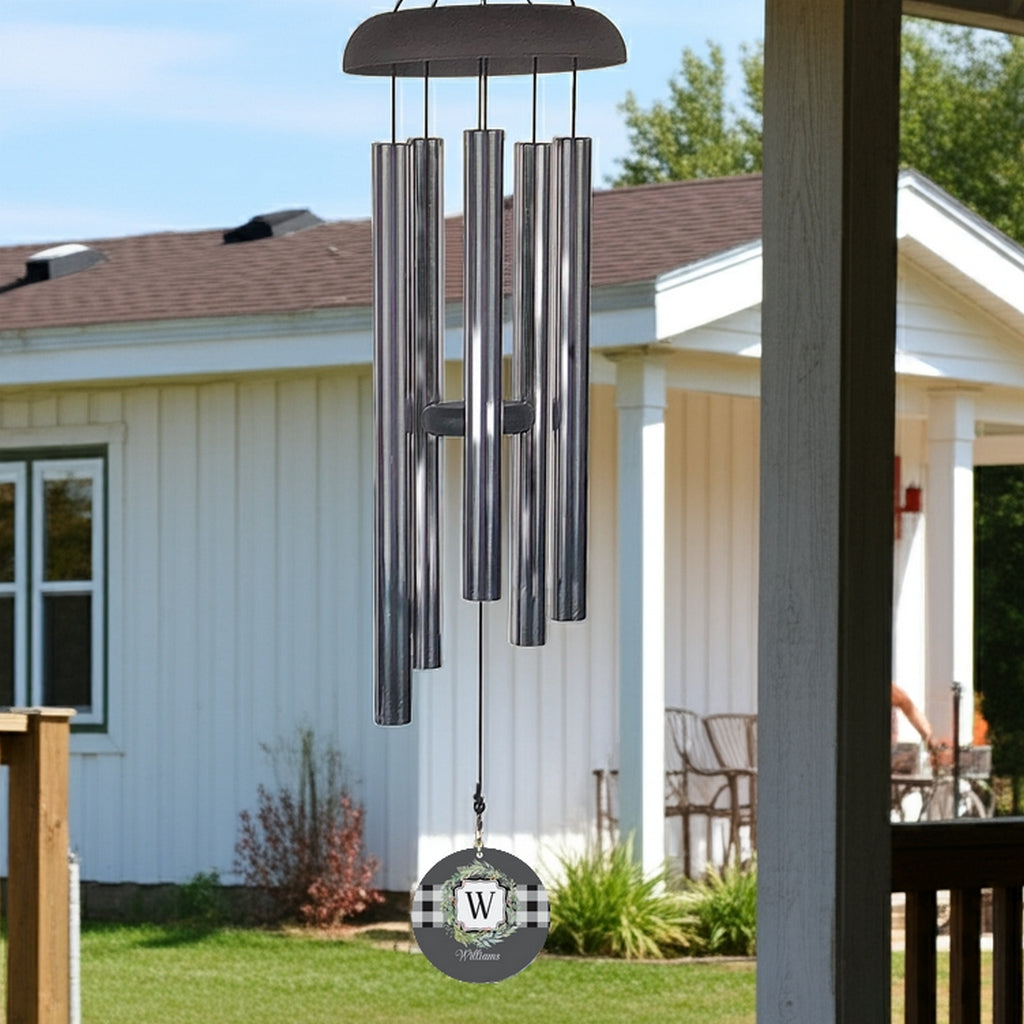 Monogram initial wind chime with metal tubes and personalized W initial hanging outdoors