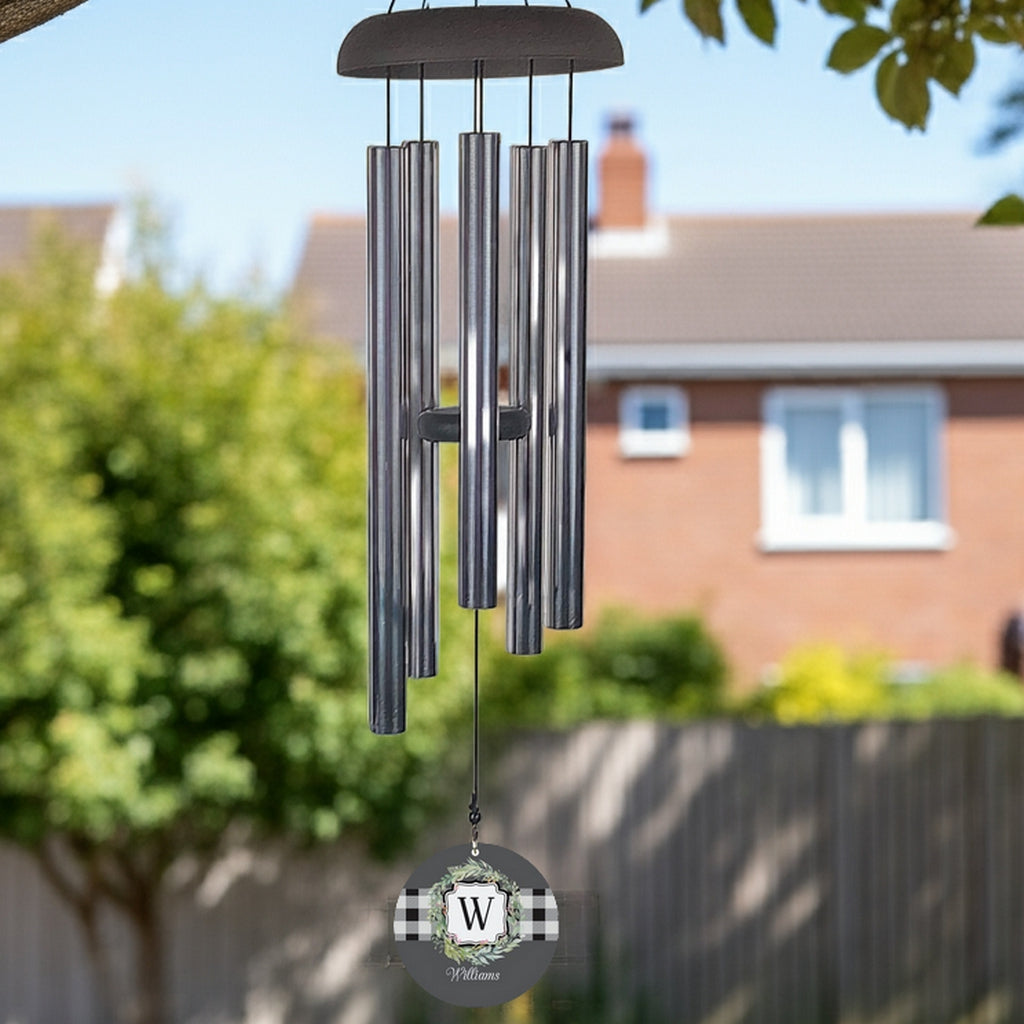 Monogram initial wind chime with metal tubes and personalized W initial wind sail hanging outdoors