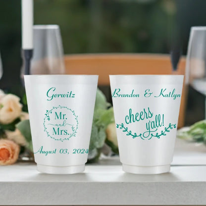 Pearl frost color plastic wedding cups customized with mr and mrs wreath design, married name and wedding date on front side and cheers y'all design and bride and groom name on back side in teal print