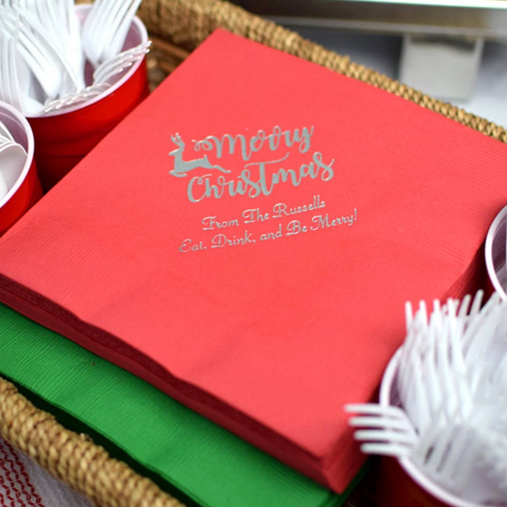 Red paper Christmas dinner napkins personalized with Merry Christmas Reindeer design and custom message in silver print