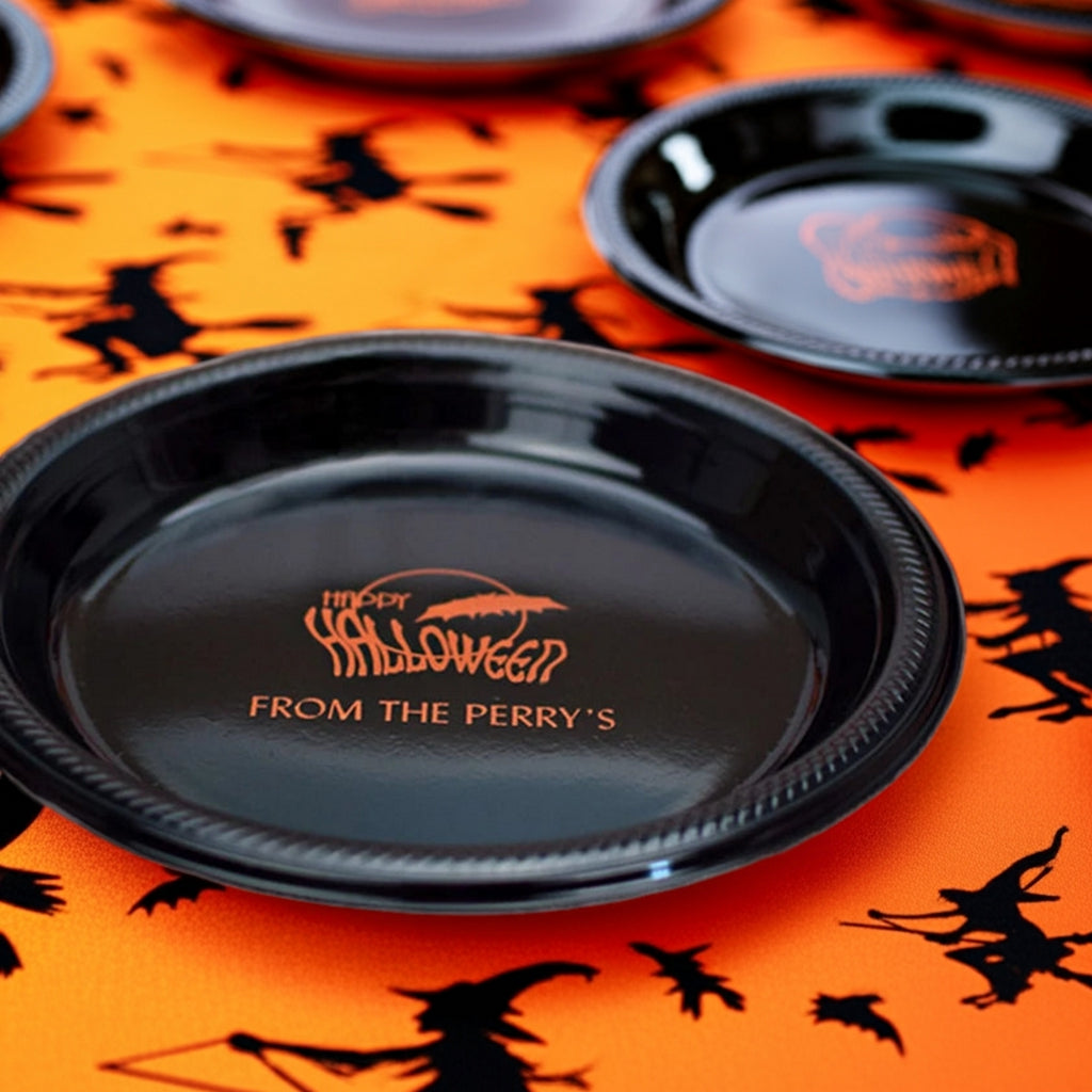 Black Halloween plates with orange custom print reading From the Perrys on personalized 10 inch plastic halloween dinner plates