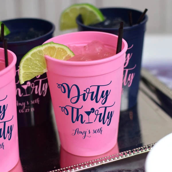 Pink 12 oz. adult birthday party stadium cup personalized with dirty thirty design and 1 line of text in black print