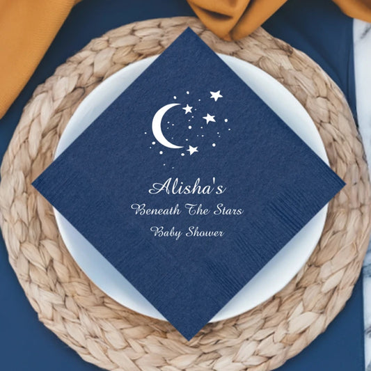 Navy color baby shower cocktail napkin personalized with moon and stars design and 3 lines of text in white print in diagonal orientation