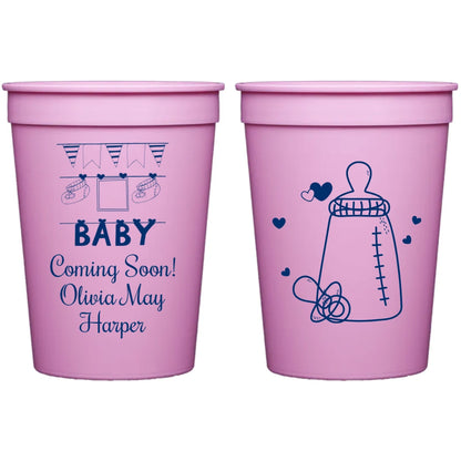Pink color 12 oz. reusable baby shower cups personalized with baby clothesline design and 3 lines of text on front side and baby bottle hearts design on back side in navy print