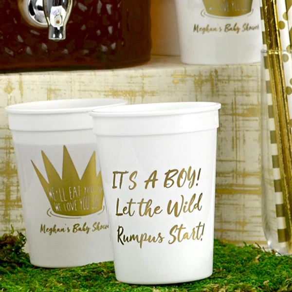 White 12 ounce size baby shower stadium cups personalized with we'll eat you up wild thing design and two lines of custom text on front side and 3 lines of large script text on back side in gold print