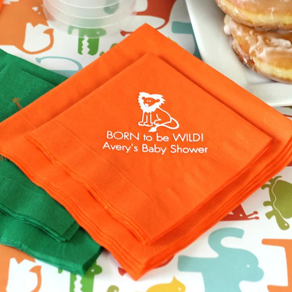 Orange color personalized baby shower beverage napkins personalized with lion design and 2 lines of custom text in white print for jungle born to be wild theme baby shower