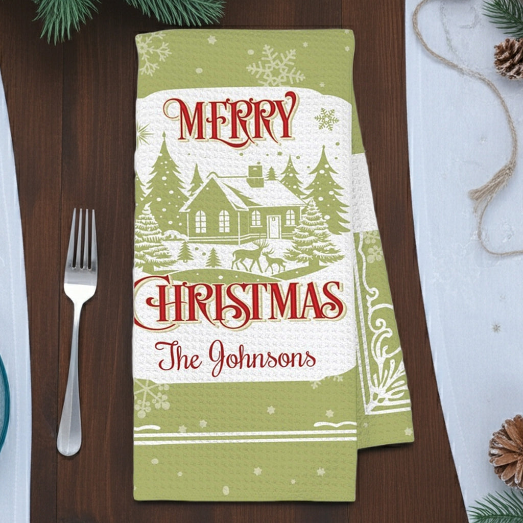 Personalized Christmas kitchen hand towel featuring a festive design with a house and trees with custom family name