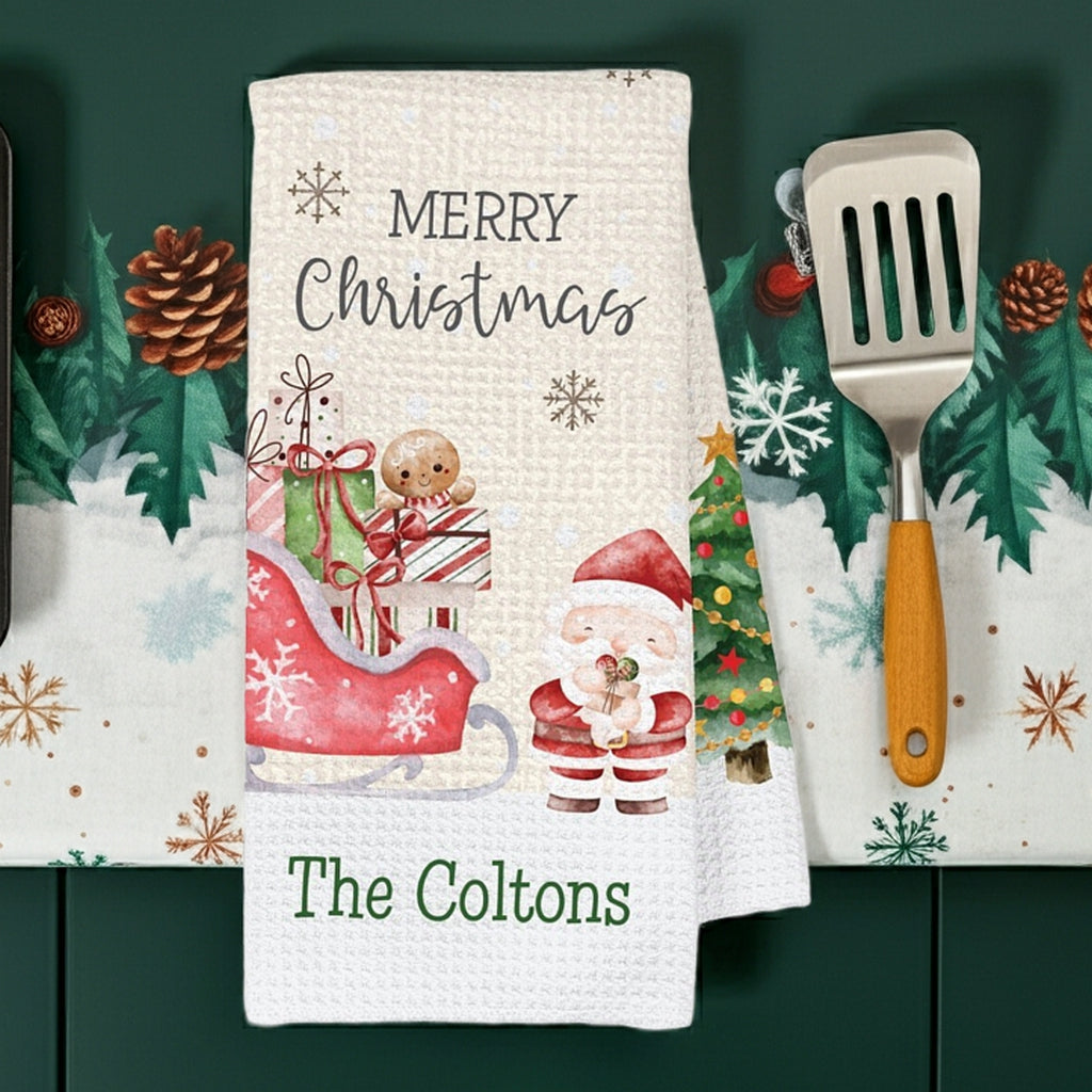 Personalized Christmas kitchen hand towel featuring Santa sleigh snowman and festive decorations for holiday cheer