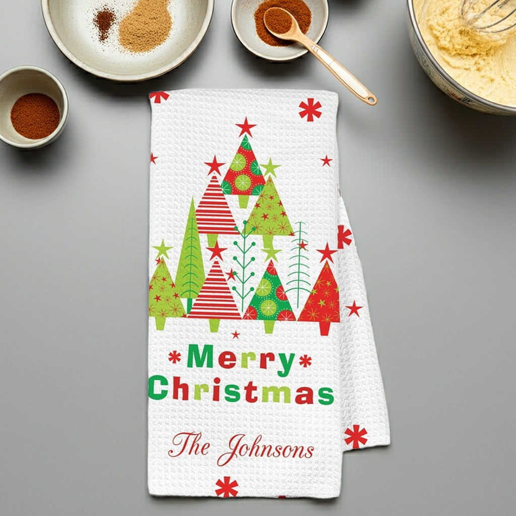 Personalized Christmas kitchen towel featuring festive trees and 'Merry Christmas The Johnsons' design