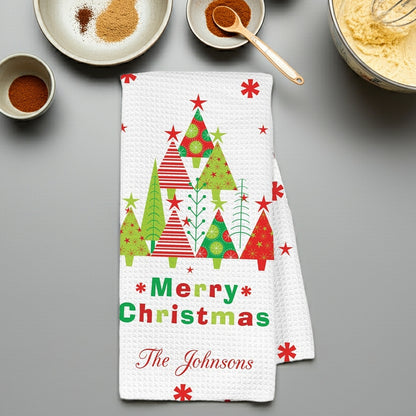 Personalized Christmas kitchen towel featuring festive trees and 'Merry Christmas The Johnsons' design