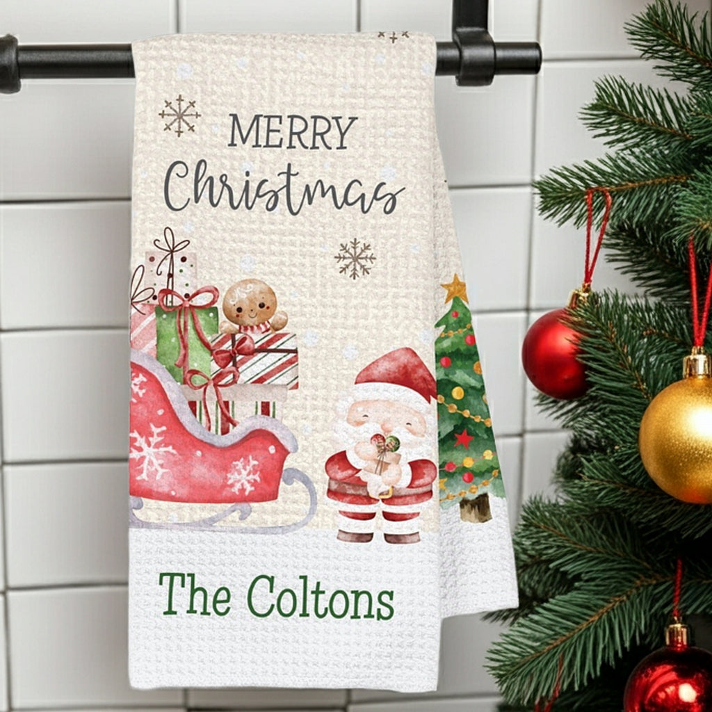 Personalized Christmas kitchen towel featuring Santa, a sleigh, and festive decorations for holiday cheer
