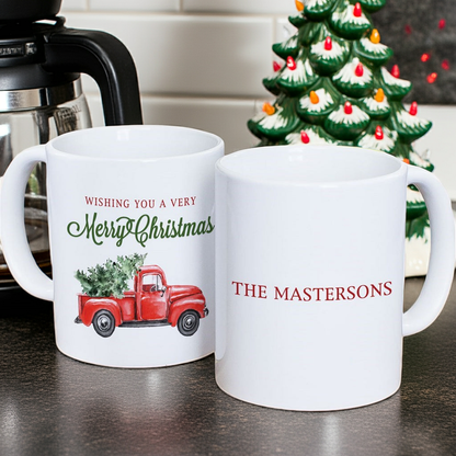 Personalized Christmas mug featuring a festive red truck and customizable family name for holiday cheer