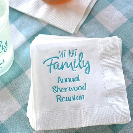 white family reunion beverage napkins personalized with we are family design and 3 lines of custom text in turquoise print