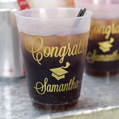 Personalized frosted plastic graduation cups with gold lettering for celebrating graduates