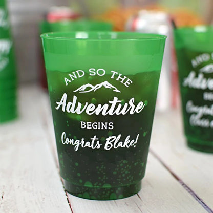 Personalized frosted plastic graduation cups with green color and adventure theme for celebrations