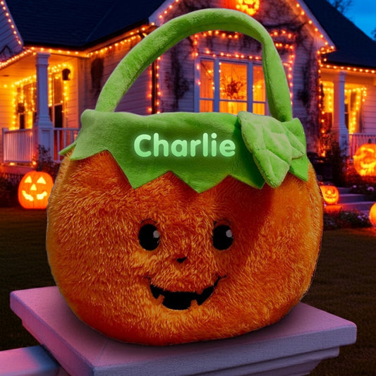 Personalized glow in the dark trick or treat basket in pumpkin design with Charlie name at Halloween night