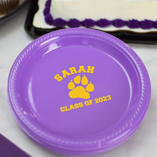 Purple plastic dessert plates personalized for graduation party with graduate name and school mascot design in yellow print