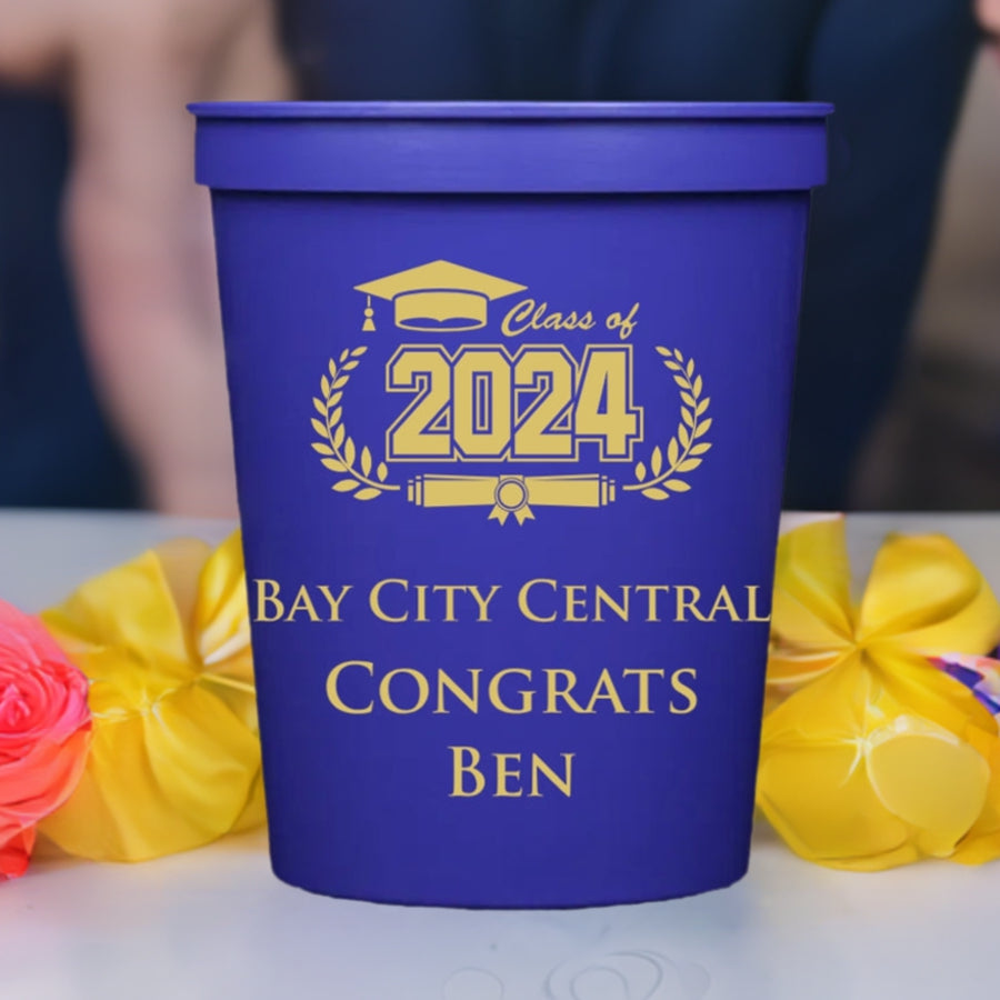 a purple graduation cup personalized with class of 2024 cap and diploma design with 3 lines of text in gold print